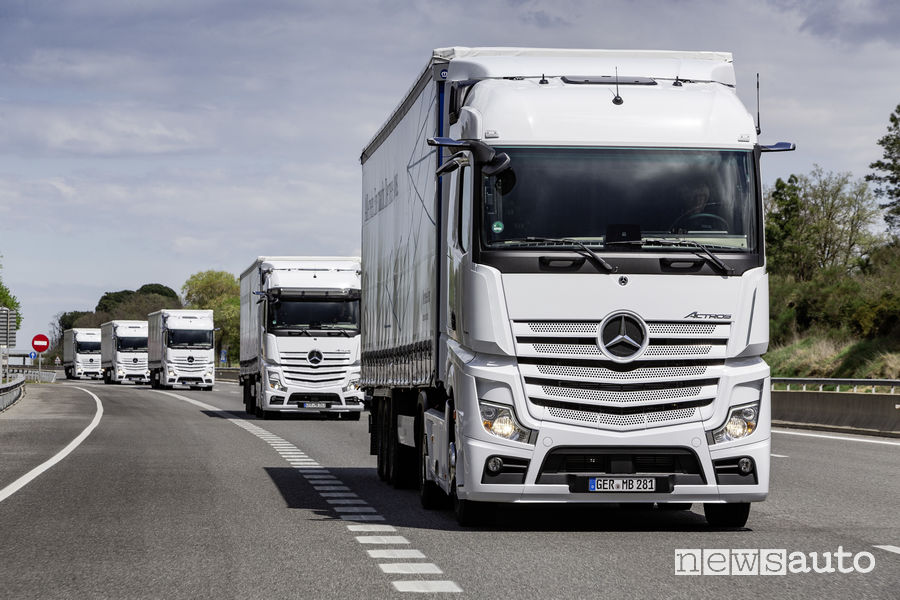 Camion Mercedes Actros bianco in fila indiana su autostrada